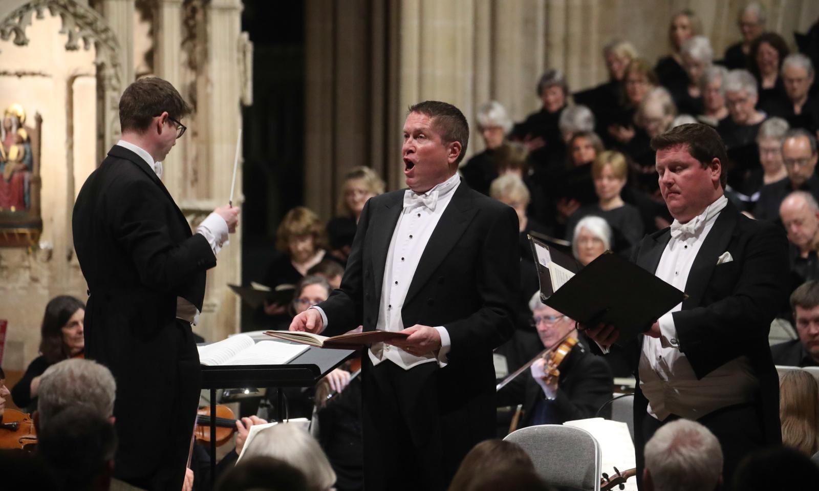 Matthew Minter performing in concert in white tie and tails.